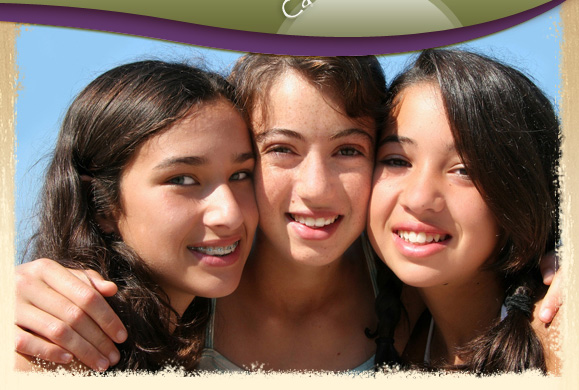 family of adults and kids smiling